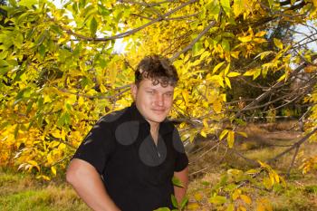 man in a black shirt on the background of autumn
