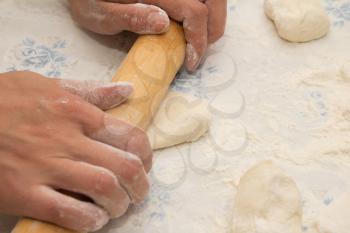 Flour in capacity with dough and rolling pin