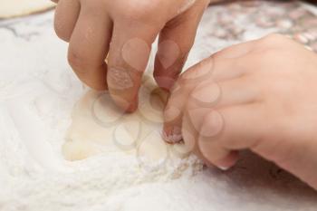 child's hands to mold the dough