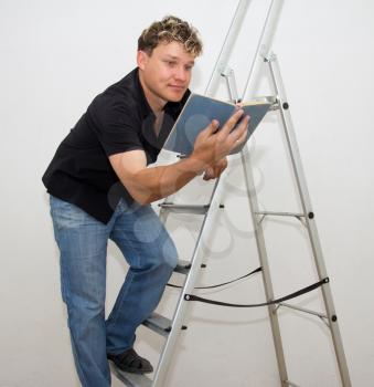 a man with a ladder and a book