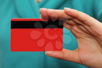 red plastic card in hand