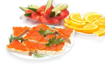 red caviar, cucumbers and tomatoes, oranges on a white background
