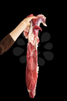 fresh meat in his hands on a black background