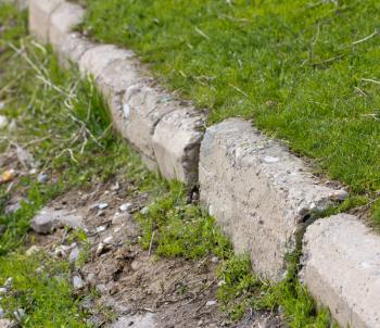 stone curbs in the grass on the road