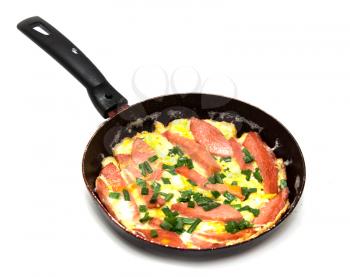 scrambled eggs with sausage in a frying pan on a white background