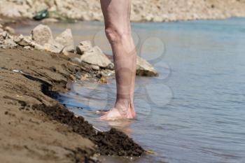 feet of the man on the beach