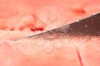 background of red watermelon with a knife. macro