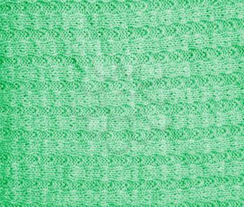 background of a green knitted fabric. texture