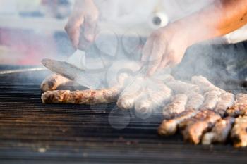Sausages are fried on a large barbecue