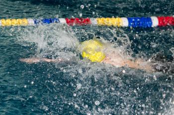 boy goes in for sports in the pool