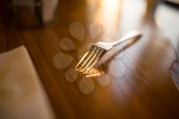 Fork on the table in the restaurant .