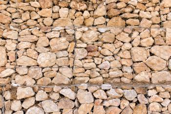 Stone wall in a grid as a background .