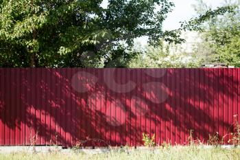 red fence made of metal in the garden .