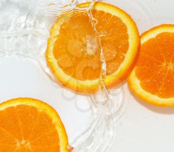 orange in water on white background