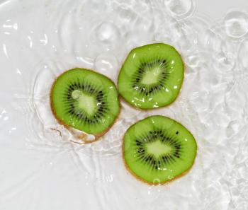 kiwi fruit in water on a white background