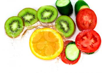 fresh fruits and vegetables in water on a white background