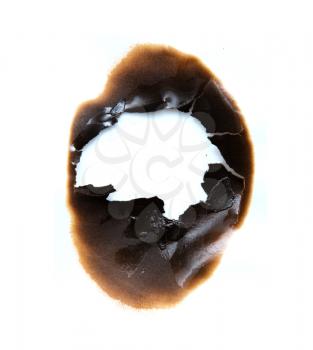 burned hole on a white paper background