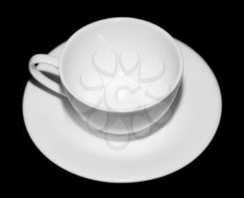 white tea saucer on a black background