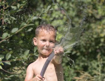 boy squirting water from a hose