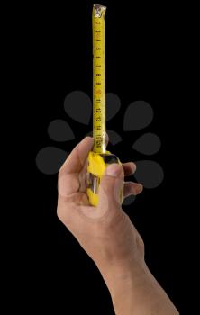 Hand with measuring tool - completely isolated on  black