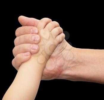 hands of father and son on a black background