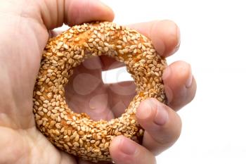 bun with sesame seeds in hand