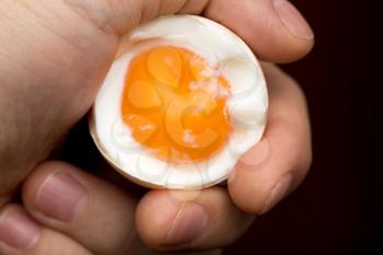 egg with yolk in a hand