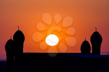 mosque silhouette at dawn sun