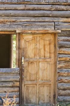 wooden door in a house with log