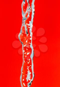a jet of water on a red background