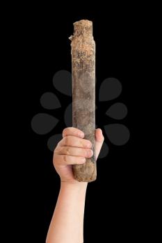 wooden stick in children's hand on a black