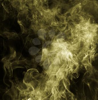 Yellow smoke against a black background
