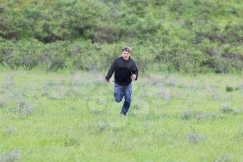 man running in a meadow