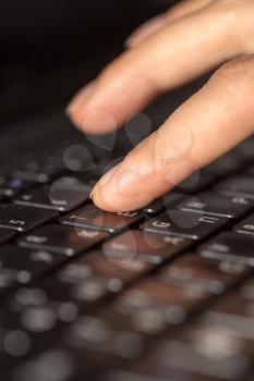 finger on a laptop keyboard