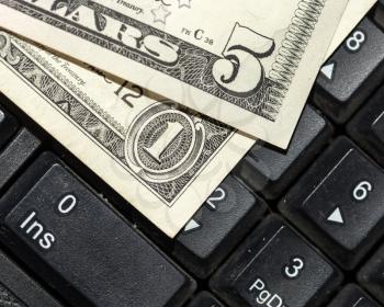 Online business concept. USA dollars bank notes on laptop keyboard