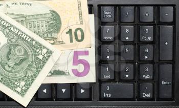 Online business concept. USA dollars bank notes on laptop keyboard