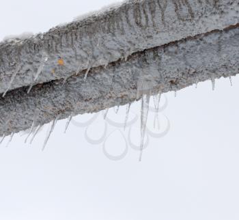 Large icicles hanging from a pipe on the nature
