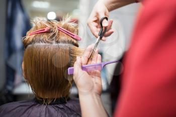 Female hair cutting scissors in beauty salon