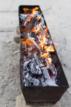 burning wood in a brazier