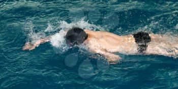 boy goes in for sports in the pool