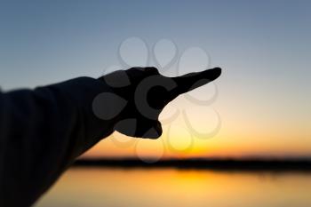 silhouette of the hand on the sunset background