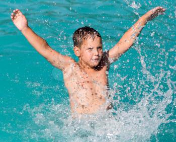 boy swims with a splash in the water park