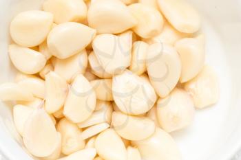 peeled garlic as background