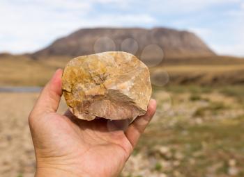 stone in hand on nature