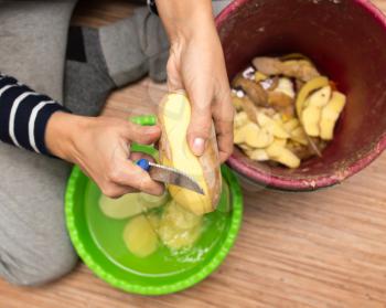 woman peeling potatoes