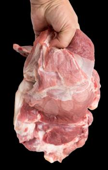 pork meat in hand on a black background