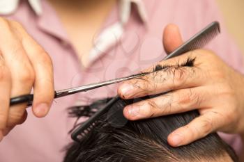 men's haircut with scissors at salon