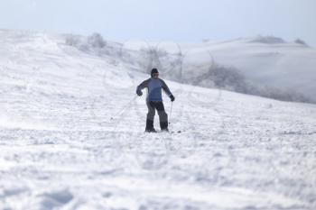 people skiing in the snow in the winter