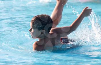 boy swims with a splash in the water park