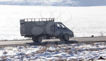 truck driving on a road in winter